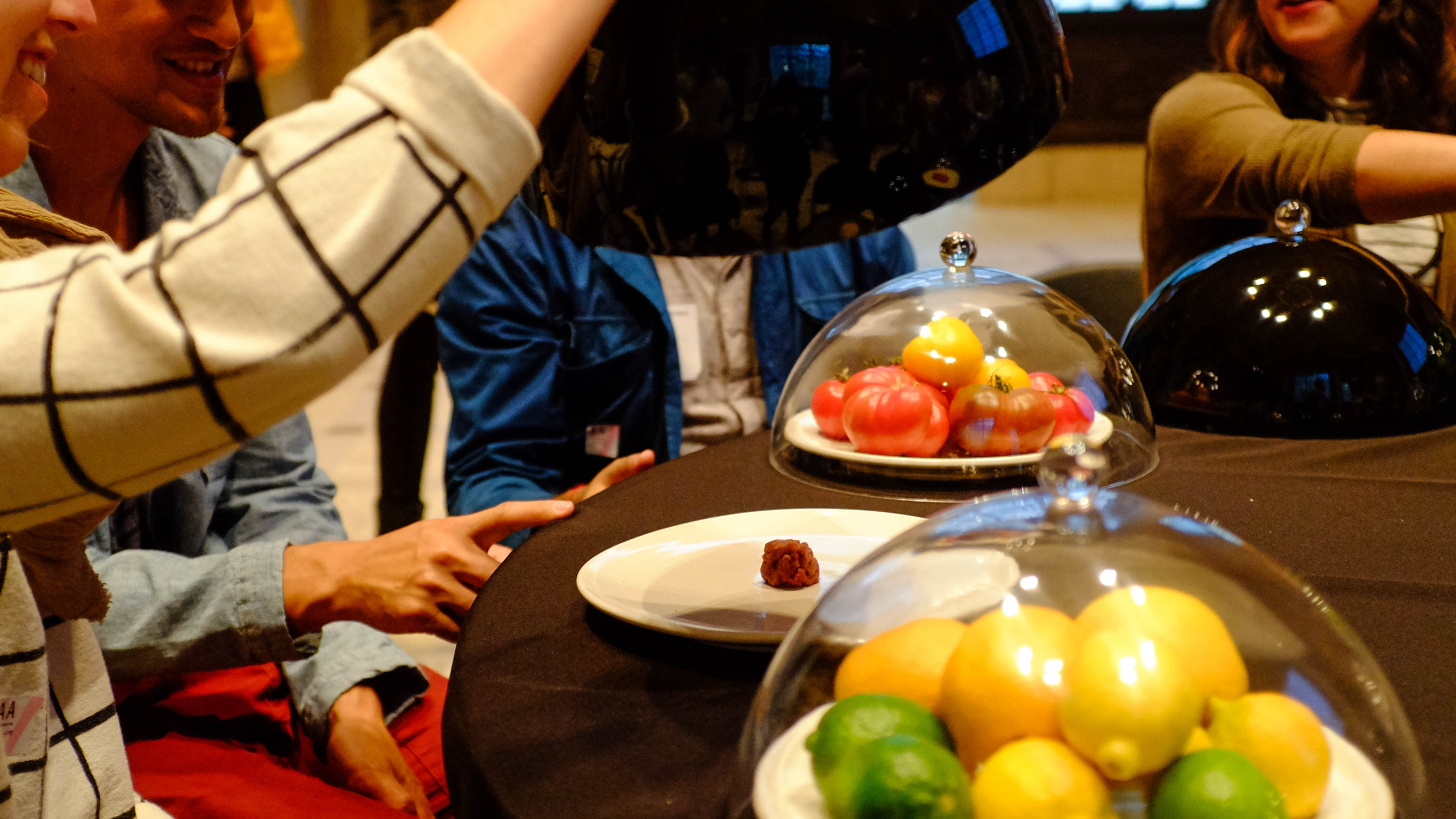 On the Menu installation — rotating table with food portions representing CO2 cost